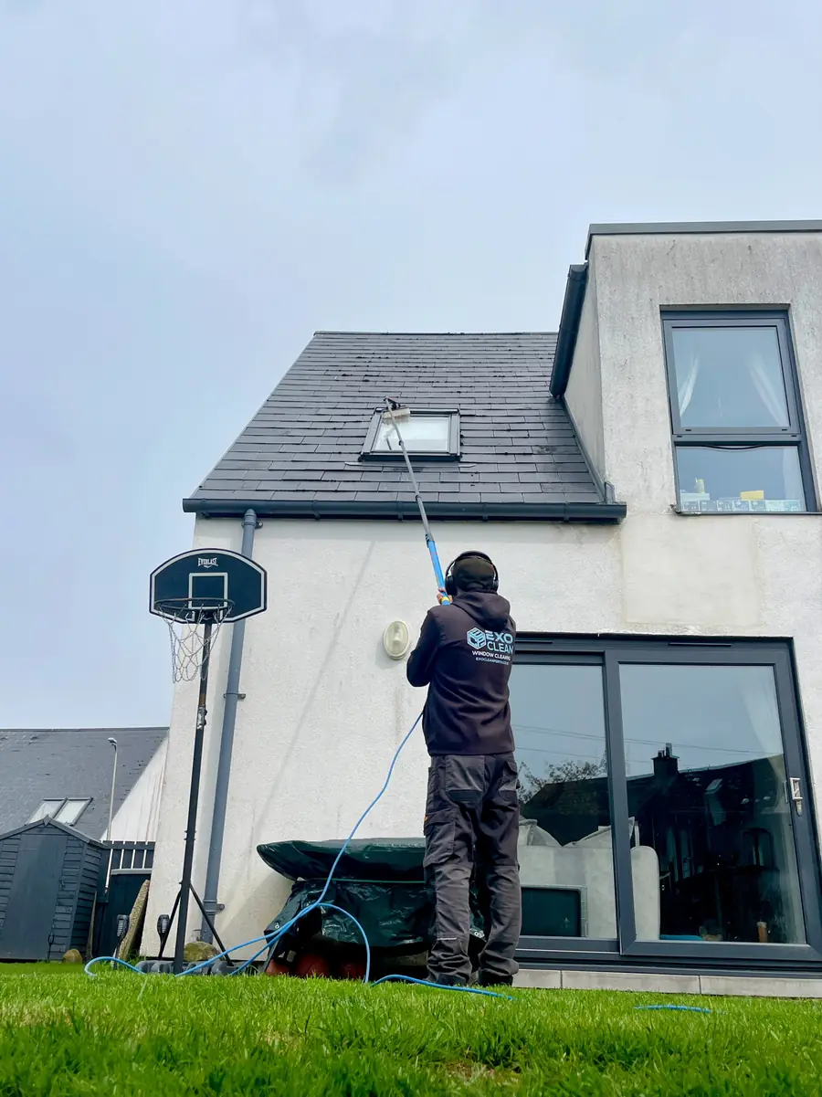 Craig cleaning a skylight from the ground with a water-fed pole